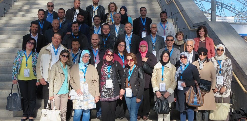 students and stakeholders standing on the stairs at the Leipzig fair, group photo
